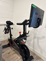Full view Peloton bike with screen and accessories