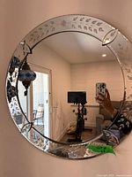 Front view of the round etched glass mirror hanging on wall