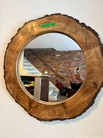 Front view of round wood frame mirror on wall