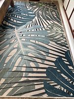 Full view of rug showing leaf pattern and overall condition