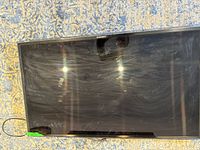 Front view of Samsung TV showing full screen and smudges