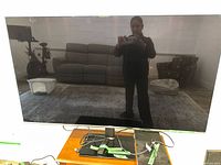 Front view of Samsung 55-inch TV on tabletop stand, screen off