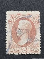 Front of 2-cent 1873 US War Department stamp showing Andrew Jackson portrait and cancellation marks