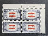 Front of plate block showing four Austria flag stamps with selvage