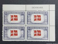 Front view of four-stamp plate block showing Denmark flag design and selvage