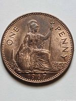 Reverse of 1967 UK one penny coin showing Britannia, denomination and date