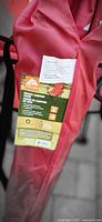Red carry bag showing product tag for deluxe camping chair