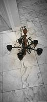 Chandelier full view showing wood column, four arms, sockets, hanging chain