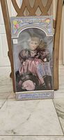 Front view of boxed Samantha Collection porcelain doll showing doll and packaging details