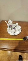Tea set assembled on serving plate showing floral pattern and gold trim