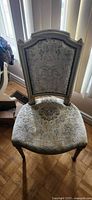 Front view of upholstered side chair showing overall design and fabric pattern