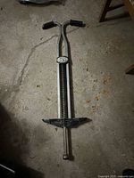 Full view of pogo stick showing handles, spring, footrests, tip