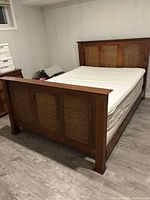 Full view of queen bed frame with mattress and topper installed