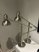Both brushed nickel adjustable desk lamps front view