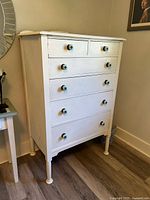 Front view showing entire dresser with five drawers and ceramic knobs