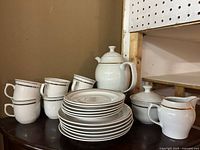 Full set showing teapot, sugar, creamer, cups and plates