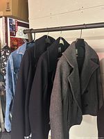 Four coats on hanging rod: denim jacket, two dark peacoats, grey Gap peacoat