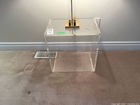 Front view of clear acrylic cube table showing transparency and open design