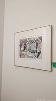 Overall view of framed abstract artwork hung on wall