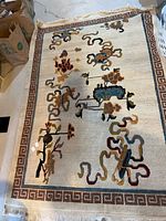 Full view of hand-knotted area rug showing entire design and colours