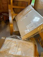 Armchair and ottoman frames with sealed cushions