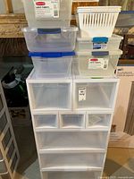 Drawer tower with clear latch-lid bins and white basket stacked on top