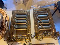 Front view of both brass framed mirrors with attached candle sconces