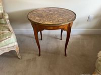 Full view of table showing marble top and legs