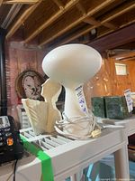 Lamp, vase, and surrounding items on shelf