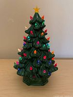 Front view of ceramic Christmas tree with multicolor peg lights and star