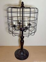 Full view of lamp showing birdcage design and base