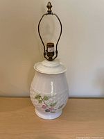 Full view of Belleek porcelain table lamp with harp and finial