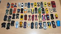 All 56 diecast vehicles arranged in rows on tabletop