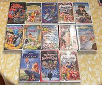 Front view of all 13 VHS tapes showing cover art