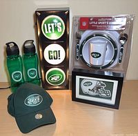 Full lot showing stoplight, cap, two water bottles, dinner set in package, clock