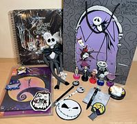 All items grouped showing activity book, gift bag, plush, stampers, magnets, pens, tin, mouse pad packaging