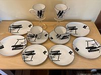 Full set on table showing plates, cups, saucers