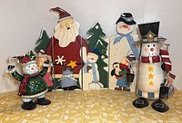 Full lot: both tin snowmen and folding wooden scene displayed