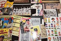 Assorted Hunt Auctions sports catalogs with baseball player covers, bobbleheads, memorabilia images