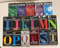 Front covers of 17 Sue Grafton alphabet novels arranged in three rows