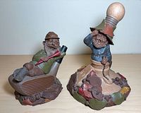 Two Thomas Clark gnome figurines side by side