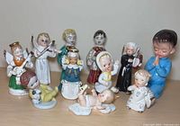 Front view of all eleven ceramic figures displayed on tabletop