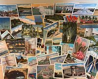 Spread of assorted color postcards with landscapes, buildings, animals