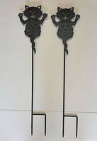 Full view of both cat stake candle holders showing height and stake design