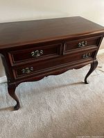 Front view of Gibbard solid mahogany sideboard showing drawers, hardware and cabriole legs
