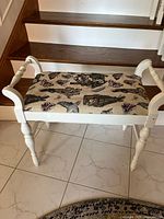 Front angled view showing white frame, turned legs and tapestry seat