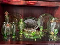full lot inside cabinet showing all green etched glass pieces