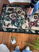 Full view of rug on floor with floral pattern visible