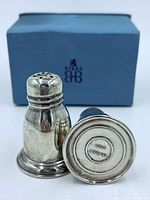 Pair of shakers, one upright, one on side showing base stamp, Birks box in background