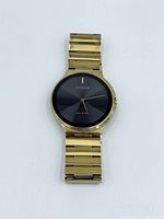 Front view of Citizen gold-tone watch showing black dial and bracelet